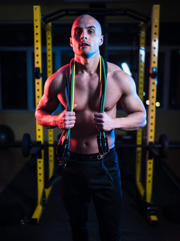 portrait-of-fitness-trainer-with-perfect-abs-holding-resistance-bands-over-neck.jpg